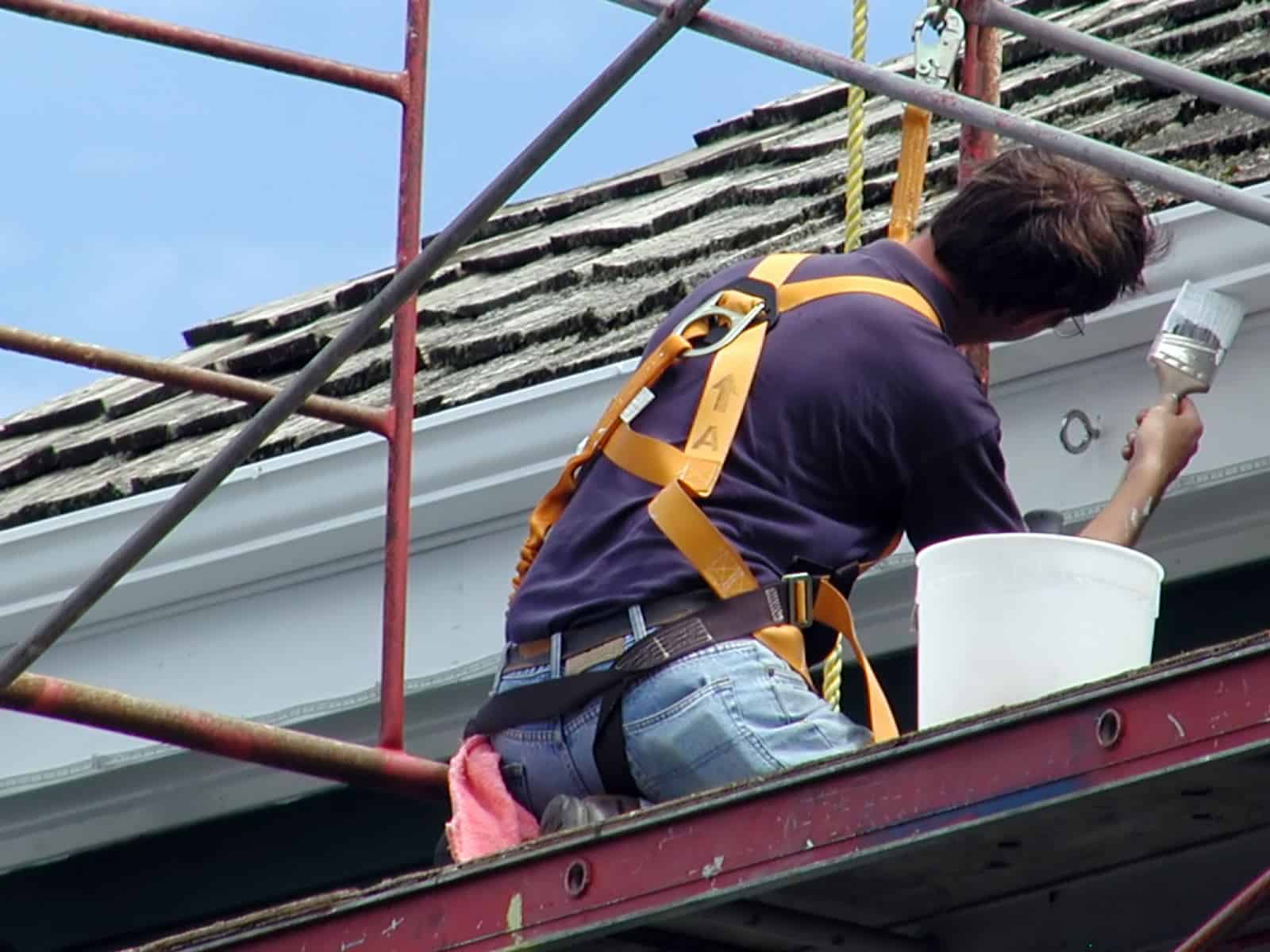 man painting a house